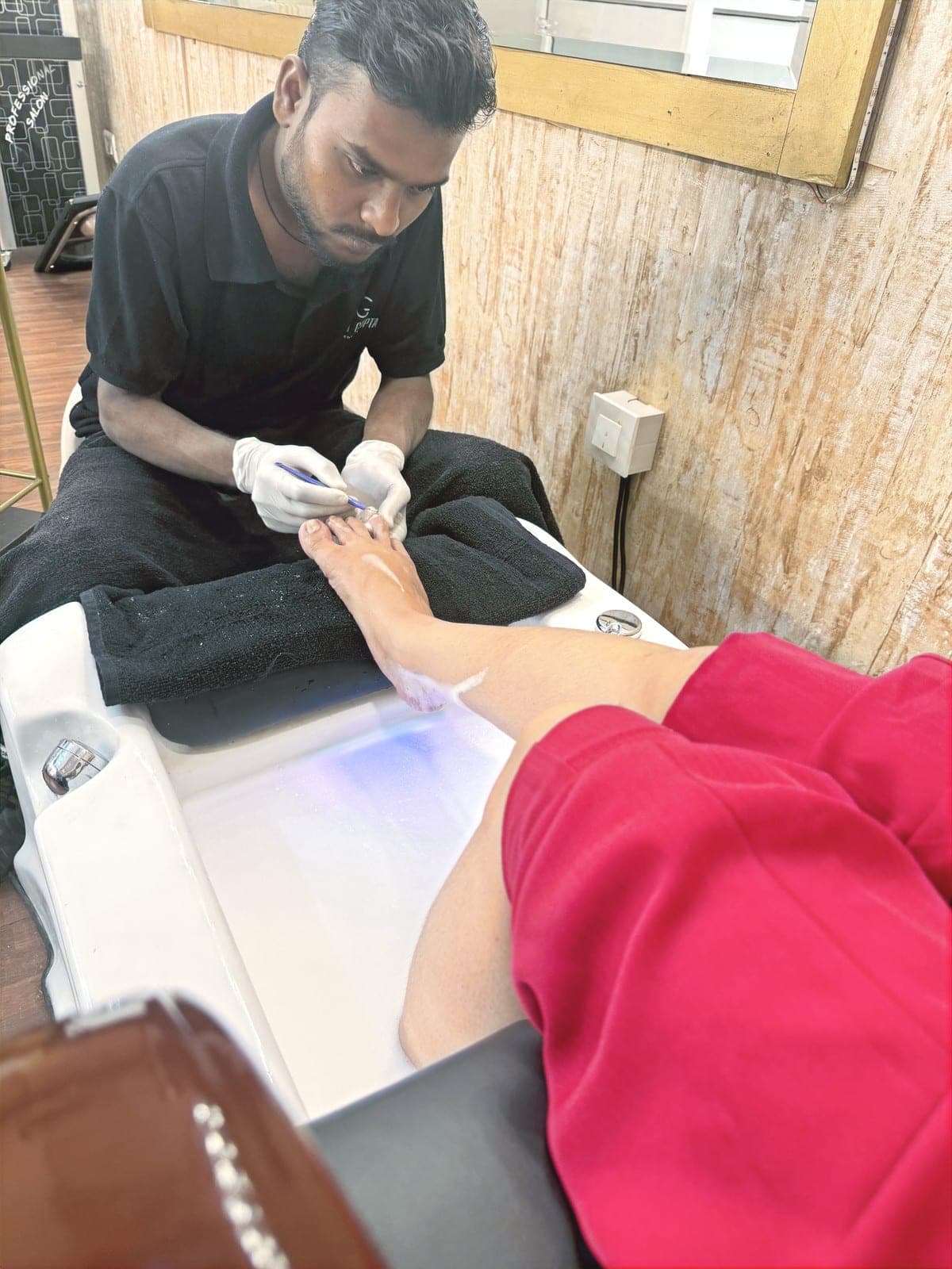 Technician giving a client a pedicure at MG Makeovers