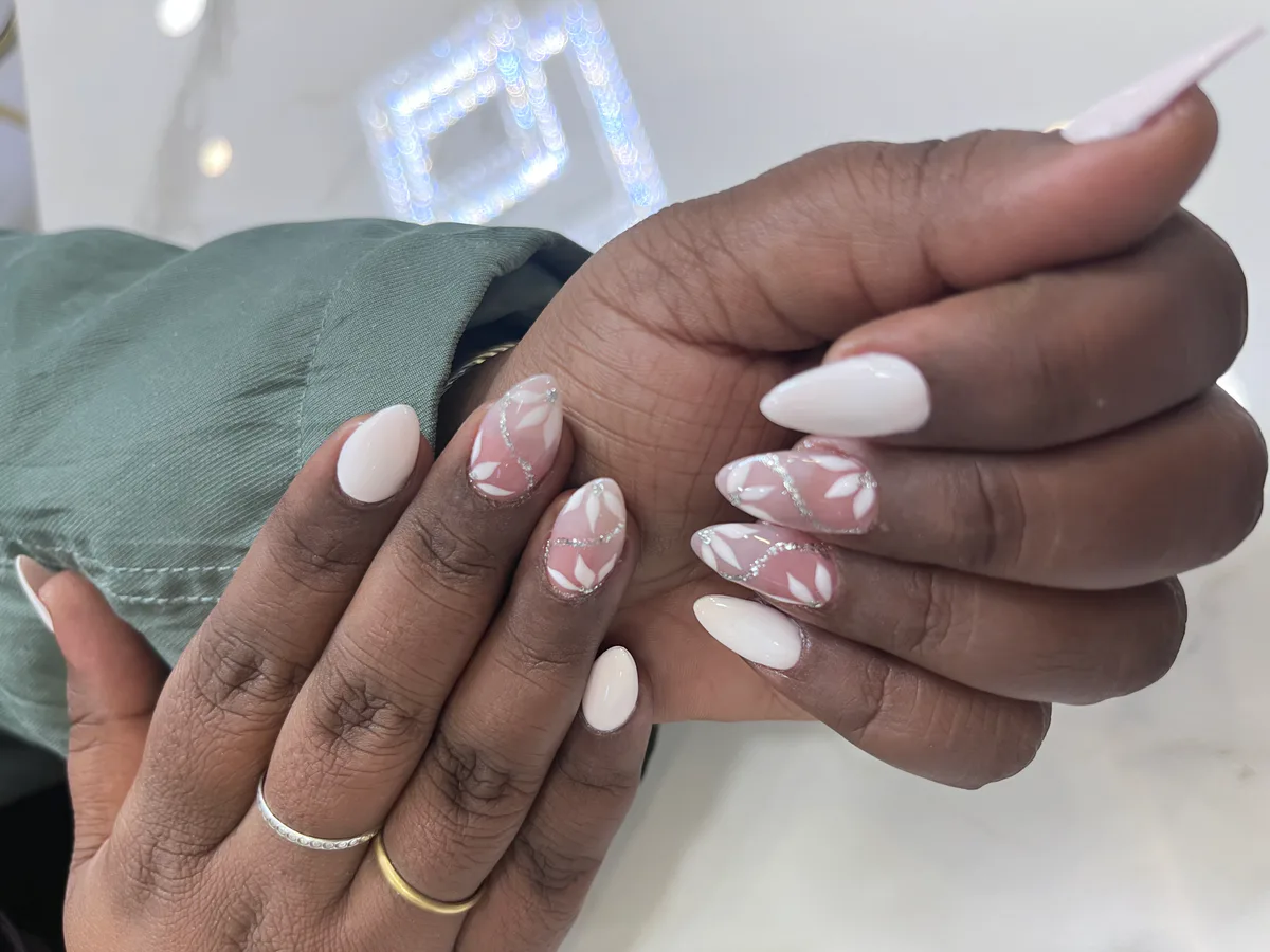 White and pink nail extensions with three-dimensional floral detail